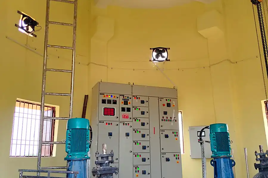Pump house interior with vertical turbine pumps and LT control panel